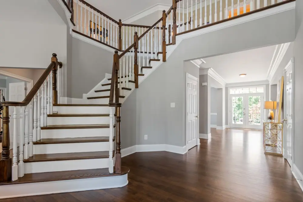 Bright entryway with a wooden staircase